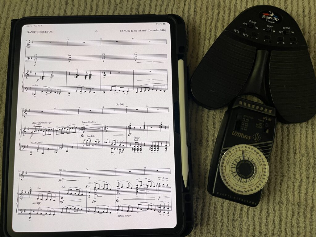 Picutre of ipad, metronome, and bluetooth page turner as part of rehearsal pianist essential tools